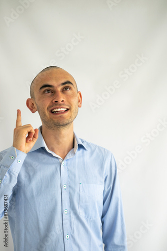 Businessman having an idea. Boy in blue shirt pointing up. Eureka