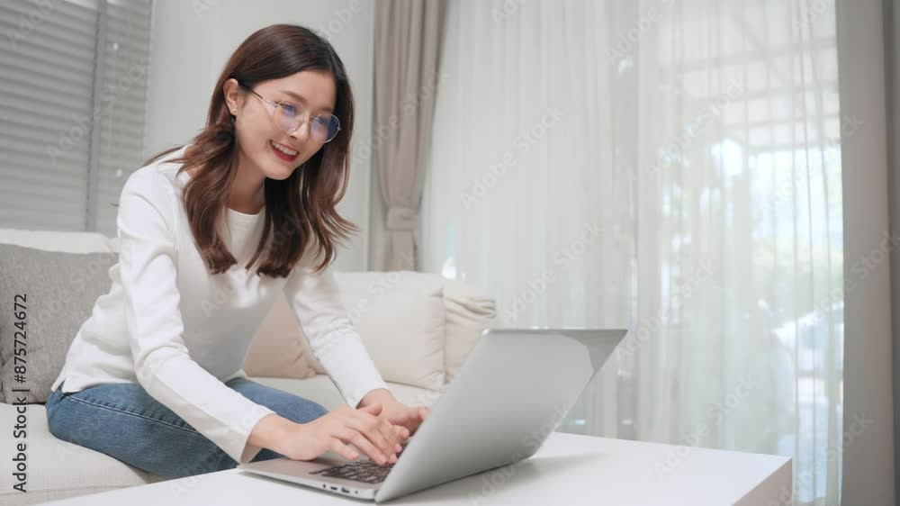 Asian female accountant typing on computer keyboard while working at home Asian female accountant typing on computer keyboard while working at home
