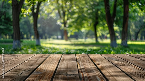 blank wooden table on green summer park background banner