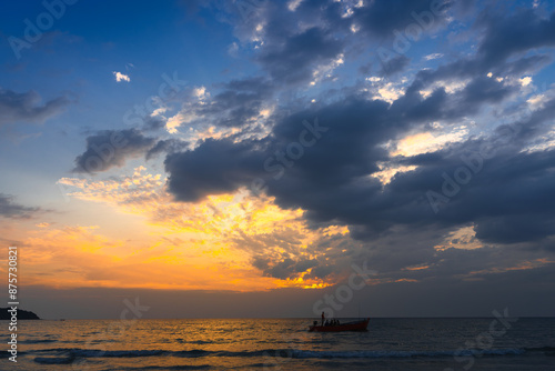 Beautiful coastline tropical beach with palm tree and beautiful colorful sky above the ocean at sunset. Summer vacation in tropical paradise  photo