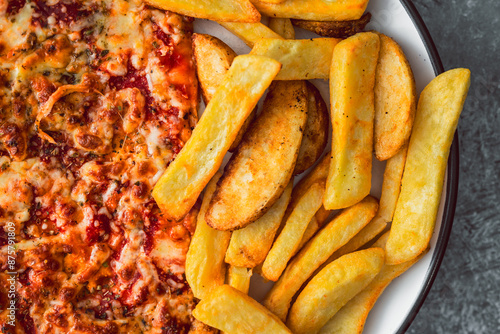 plate with half pizza half chips, concpet of fast food or unhealthy food with lots of carbs