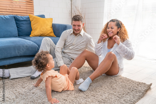 Family. Happy family with little daughte having fun at home. Smiling young parents and their child are very happy. Parenthood and people concept.	 photo