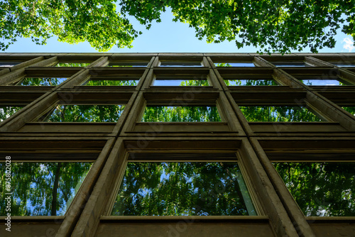 A concrete façade with reflective light in the windows, Berlin, Germany