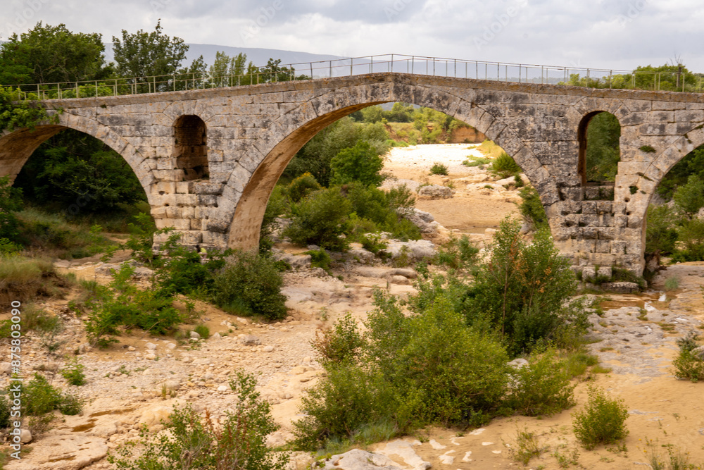 The Pont Julien, famous Roman bridge in Bonnieux, Luberon, France, dates back 2000 years. It spans the Calavon River in three arches The Pont Julien, famous Roman bridge in Bonnieux, Luberon, France, dates back 2000 years. It spans the Calavon River in three arches