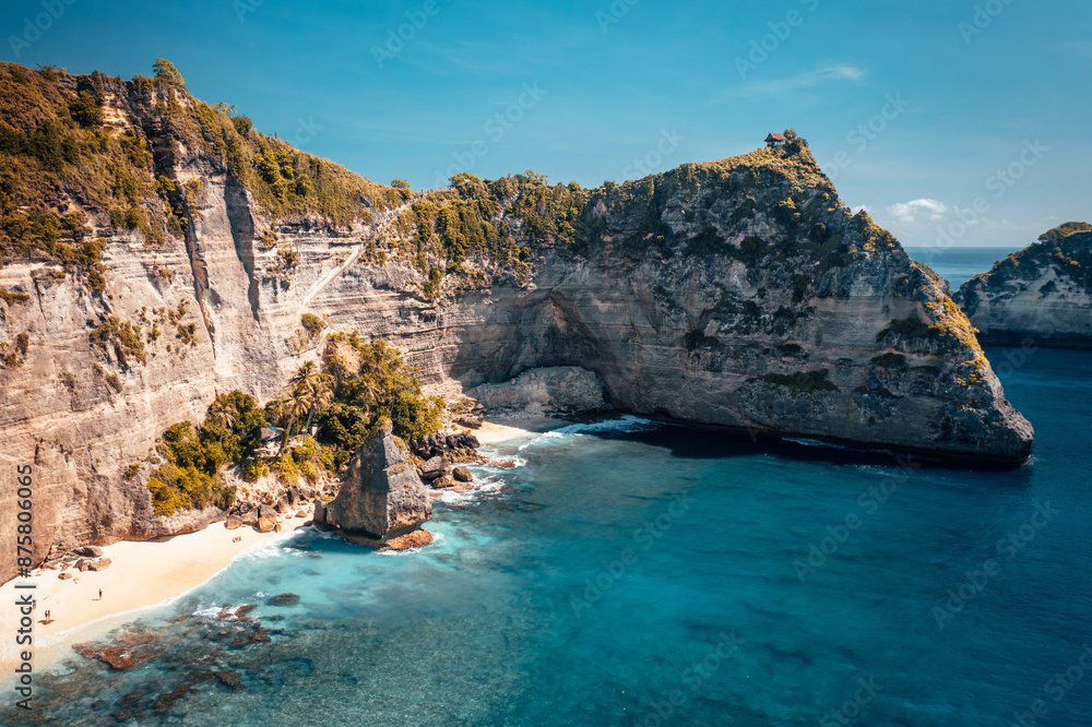Fototapeta premium One of the most beautiful travel destination Bali, amazing Diamond Beach Bali with crystal clear azure sea water and scenery mountain rocks in ocean on nature background Bali Indonesia 4K Aerial view