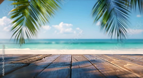 A mock-up of an empty wooden table with a place to copy text, against the background of a summer beach, sea, waves, pool, green palm trees around.