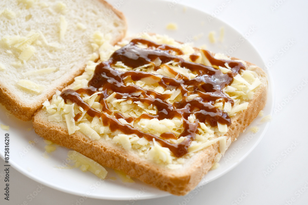 Cheese sandwich with brown sauce on a white plate. Cheese sandwich with brown sauce on a white plate.
