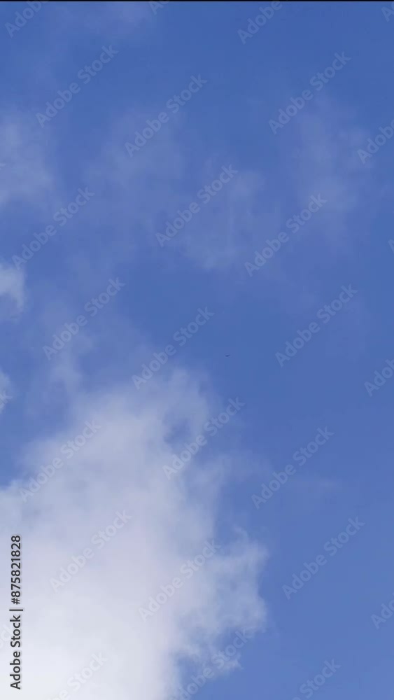 time lapse of white clouds blowing in the wind against a blue sky background in summer time lapse of white clouds blowing in the wind against a blue sky background in summer