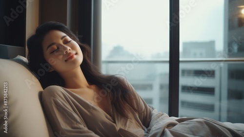 Simple lifestyle, Asian woman wakes up from good sleep on weekend morning, takes some rest, relax in comfortable bedroom at hotel window, happy lazy day, comfortable, dreaming