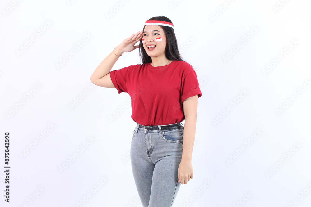 Beautiful Asian woman giving salute celebrate Indonesian independence day on17 August wearing red top and flag headband isolated over white background Beautiful Asian woman giving salute celebrate Indonesian independence day on17 August wearing red top and flag headband isolated over white background