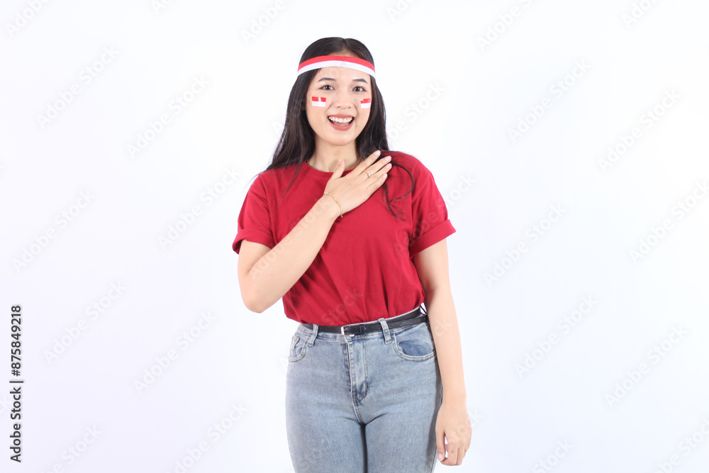 A young Asian woman with a happy successful expression wearing red top and flag headband isolated by white background, hands on chest Indonesia's independence day concept. A young Asian woman with a happy successful expression wearing red top and flag headband isolated by white background, hands on chest Indonesia's independence day concept.