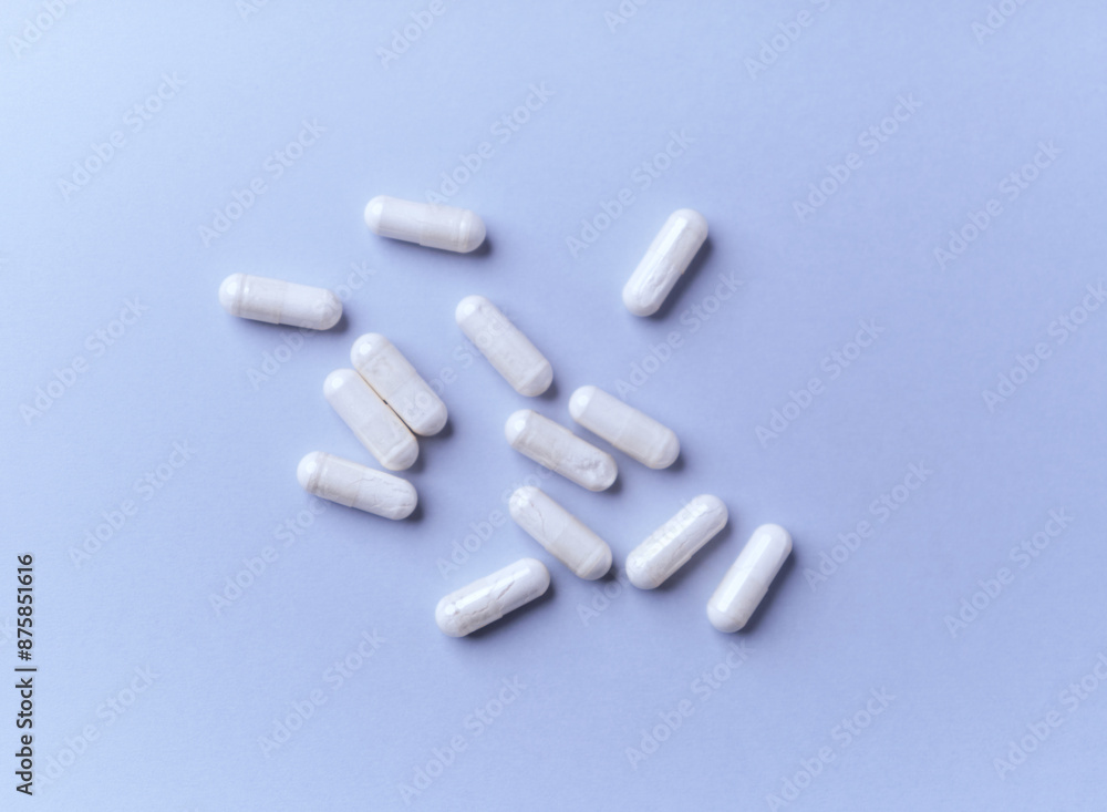 Tyrosine capsules (one of the 20 standard amino acids). A dietary supplement used to improve attention and focus on paper background. Soft focus. Close up. Tyrosine capsules (one of the 20 standard amino acids). A dietary supplement used to improve attention and focus on paper background. Soft focus. Close up.