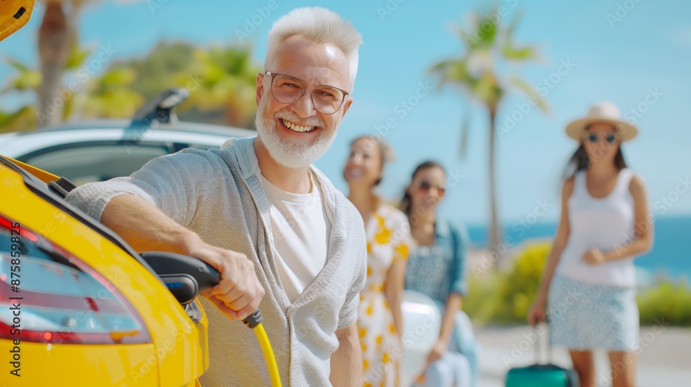 Happy father holding power supply cable and charging their electric car, rest of family putting suitcases in car trunk, preparating for holidays. Happy father holding power supply cable and charging their electric car, rest of family putting suitcases in car trunk, preparating for holidays.