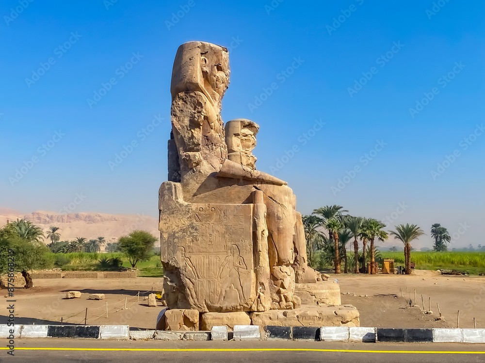 Fototapeta premium Colossi of Memnon, two massive stone statues representing the pharaoh, Luxor, Egypt