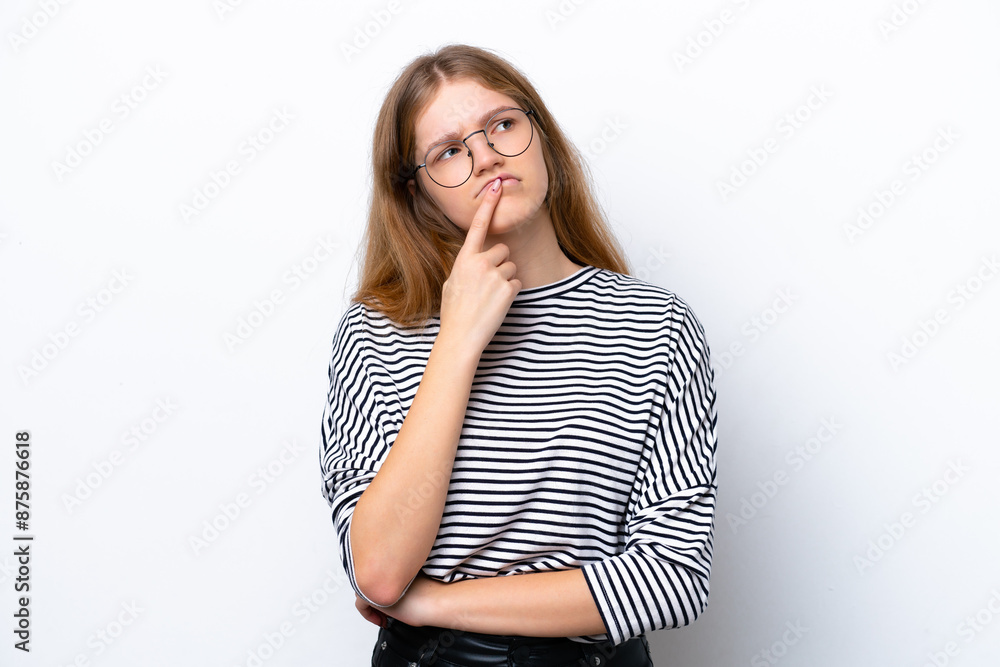 Teenager Russian girl isolated on white background having doubts while looking up Teenager Russian girl isolated on white background having doubts while looking up
