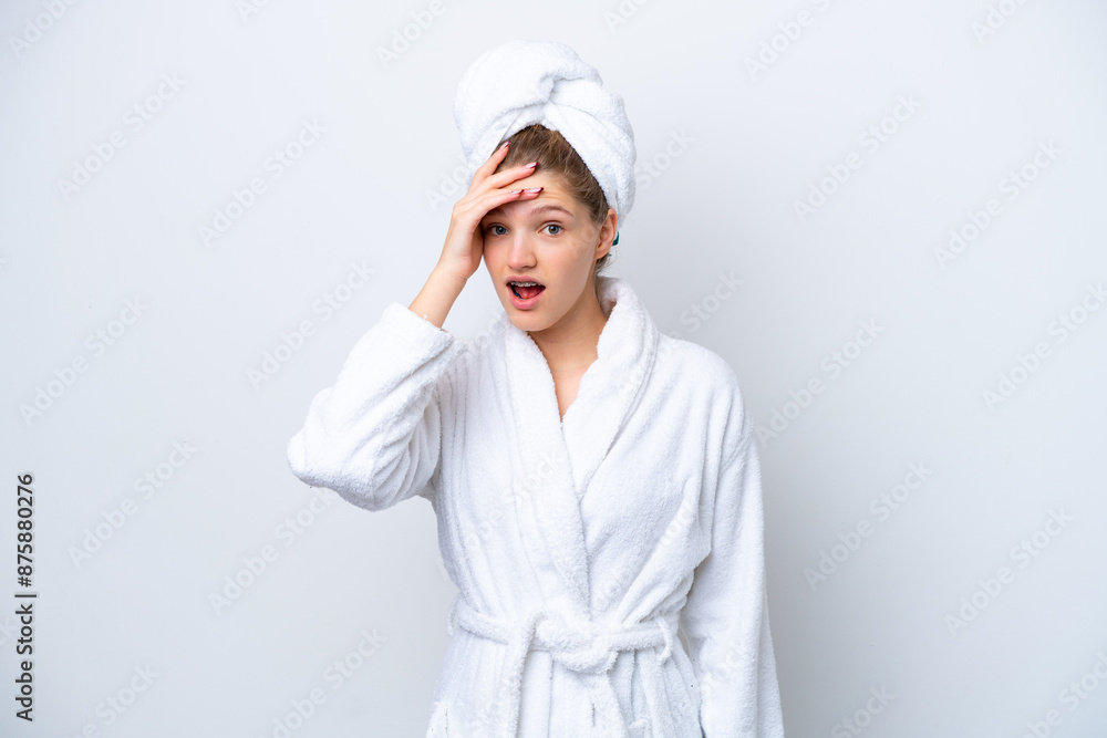 Teenager Russian girl in a bathrobe isolated on white background doing surprise gesture while looking to the side Teenager Russian girl in a bathrobe isolated on white background doing surprise gesture while looking to the side