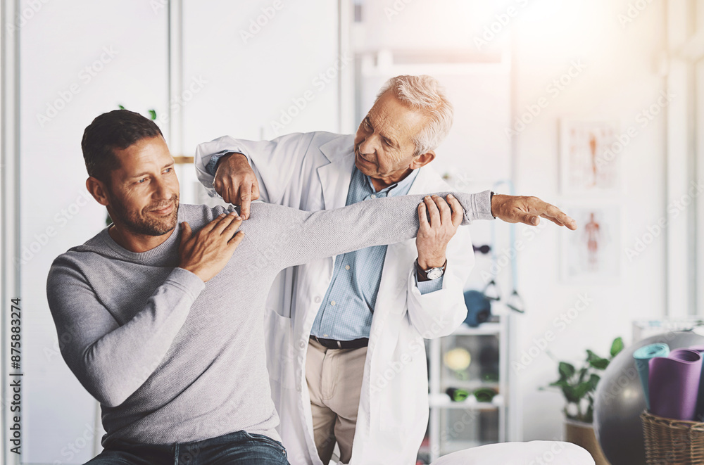 Fototapeta premium Senior doctor, man and patient with shoulder pain for physical therapy, stretching and body recovery. Orthopedic, physician and medical expert for arm consultation with examination, advice or healing
