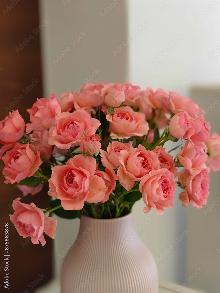 Obraz premium Elegant bouquet of vibrant pink roses in a simple, matte vase, beautiful arrangement creates a serene and inviting ambiance, making it an ideal centerpiece to enhance any room with touch of nature