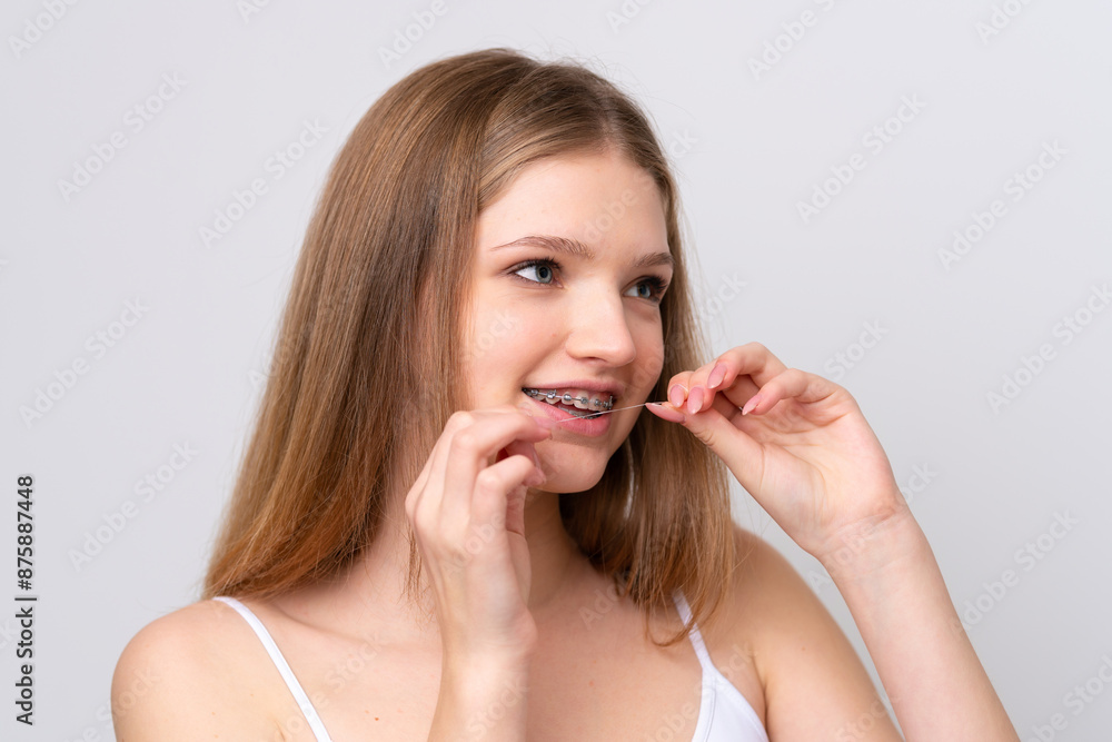Teenager Russian girl isolated on white background with dental floss. Close up portrait Teenager Russian girl isolated on white background with dental floss. Close up portrait