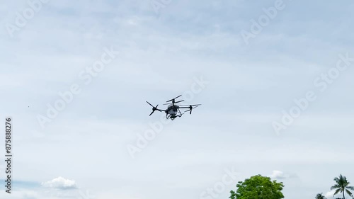 Agriculture drone fly to sprayed fertilizer on the sweet corn fields. Drone transporter.
