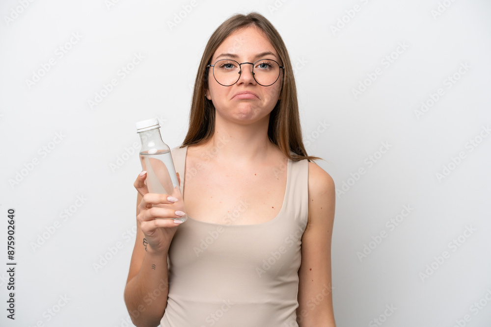 Young Lithuanian woman with a bottle of water isolated on white background with sad expression Young Lithuanian woman with a bottle of water isolated on white background with sad expression