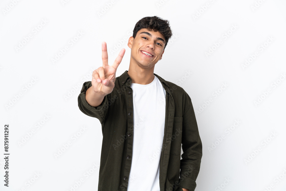 Young man over isolated white background smiling and showing victory sign