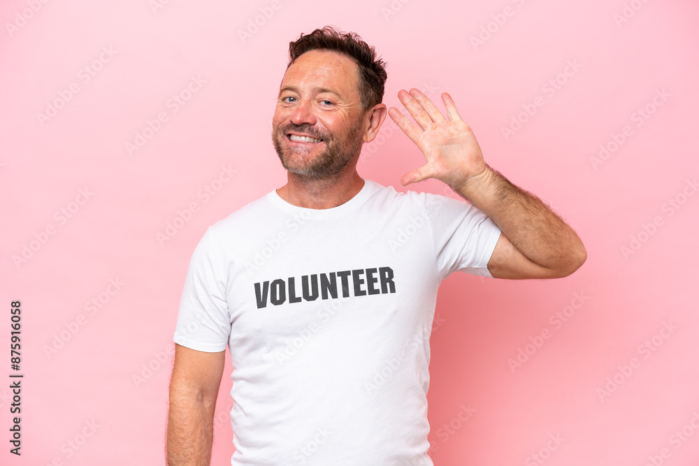 Fototapeta premium Middle age volunteer man isolated on pink background isolated on pink background counting five with fingers
