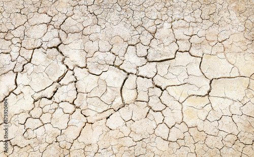Texture of the dried earth with clay and sand, close-up or Brown dry soil or cracked ground texture background.