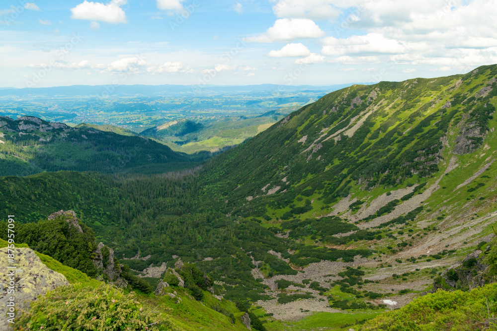 View from the top of the mountain. Beautiful mountain landscape in summer. Tatra Mountains View from the top of the mountain. Beautiful mountain landscape in summer. Tatra Mountains
