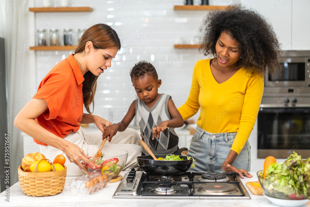 Diversity young happy love LGBT, LGBTQ caucasian and african family lesbian couple woman cook vegan food healthy eat with fresh vegetable salad in kitchen at home, pride, rainbow.Lgbt lesbian couple Diversity young happy love LGBT, LGBTQ caucasian and african family lesbian couple woman cook vegan food healthy eat with fresh vegetable salad in kitchen at home, pride, rainbow.Lgbt lesbian couple