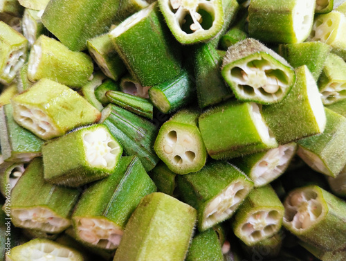 Sliced okra lady's fingers heap green lady finger bhindi vegetable food seedpods vegfood gombo okro damen-finger quimbombo quiabo bhindee abelmoschus esculentus image green bhindi photo. photo