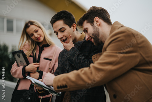 Group of young adults in an informal outdoor setting focused on discussing marketing trends and strategies for business growth.