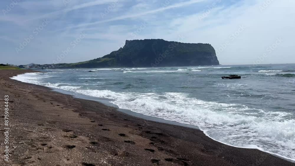Sea coast landscape at South Korean Jeju Island. Clear water and black volcanic stones, waves on rocky and sand beach. Sea coast landscape at South Korean Jeju Island. Clear water and black volcanic stones, waves on rocky and sand beach.