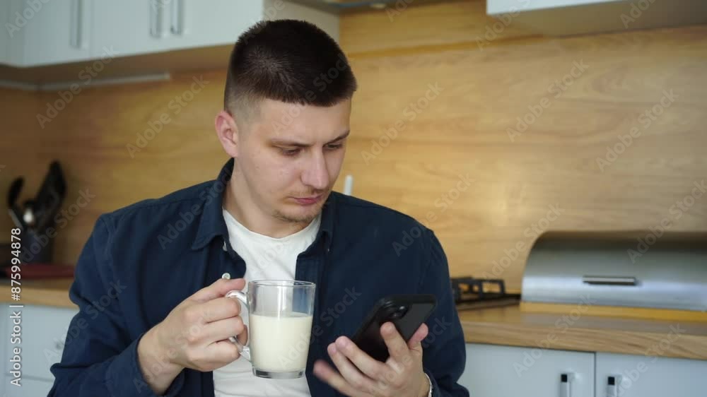 a man drinks milk and looks at the phone.
A glass of milk and a phone in the hands of a man.
Man reading news on his phone a man drinks milk and looks at the phone.
A glass of milk and a phone in the hands of a man.
Man reading news on his phone