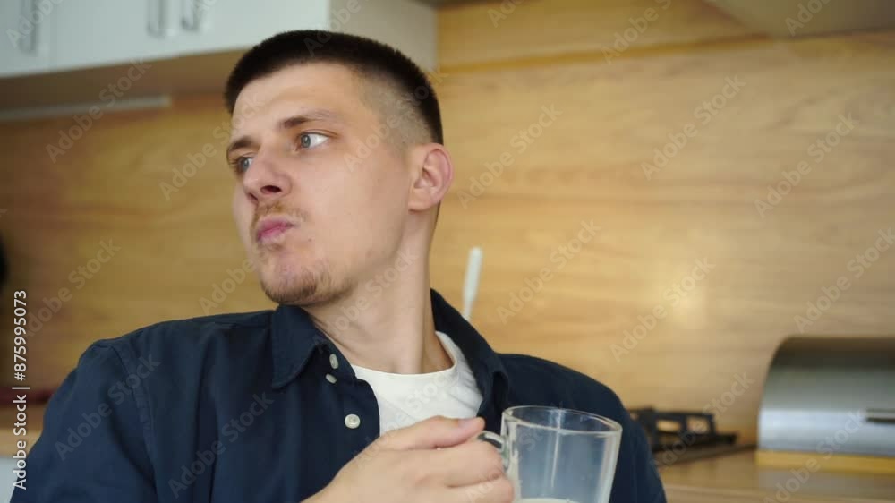 A guy sits in the kitchen and drinks milk from a transparent cup.
Cup with milk.
Drink, milk, healthy A guy sits in the kitchen and drinks milk from a transparent cup.
Cup with milk.
Drink, milk, healthy
