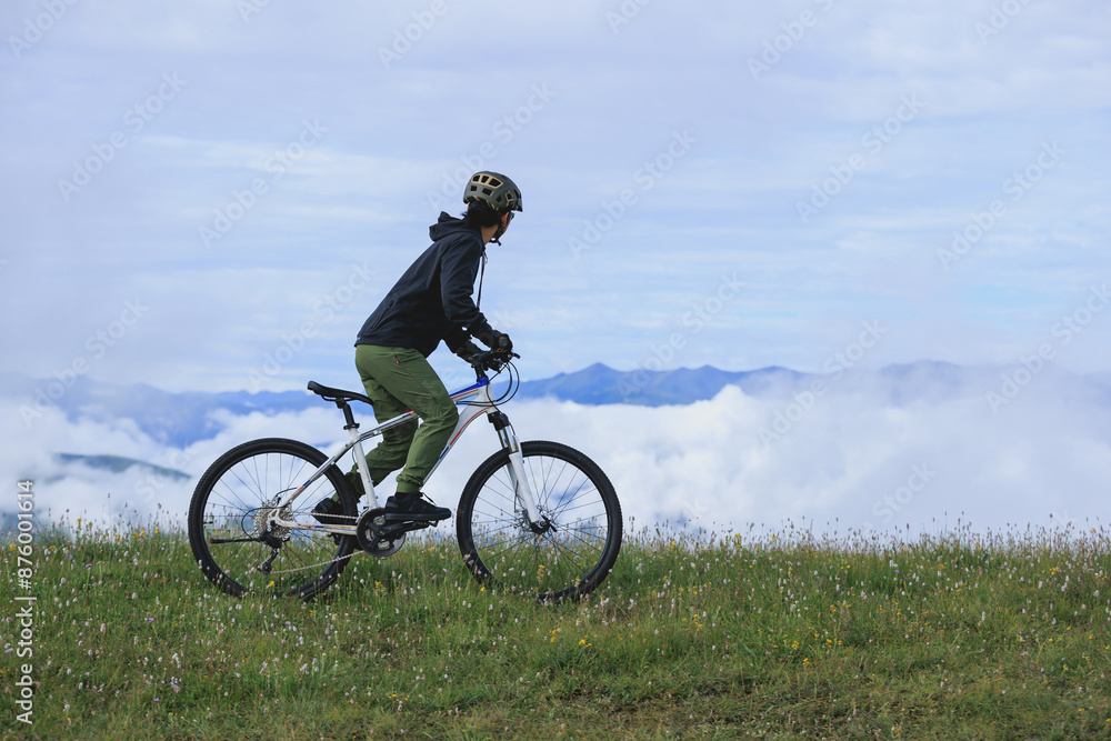 Riding mountain bike on beautiful mountain top Riding mountain bike on beautiful mountain top