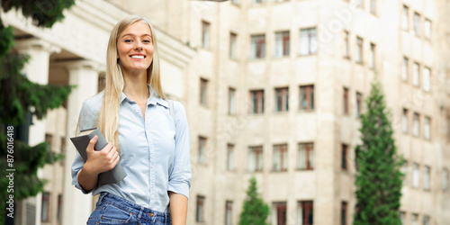 Happy girl resting between classes near university, smiling to camera outdoors, copy space