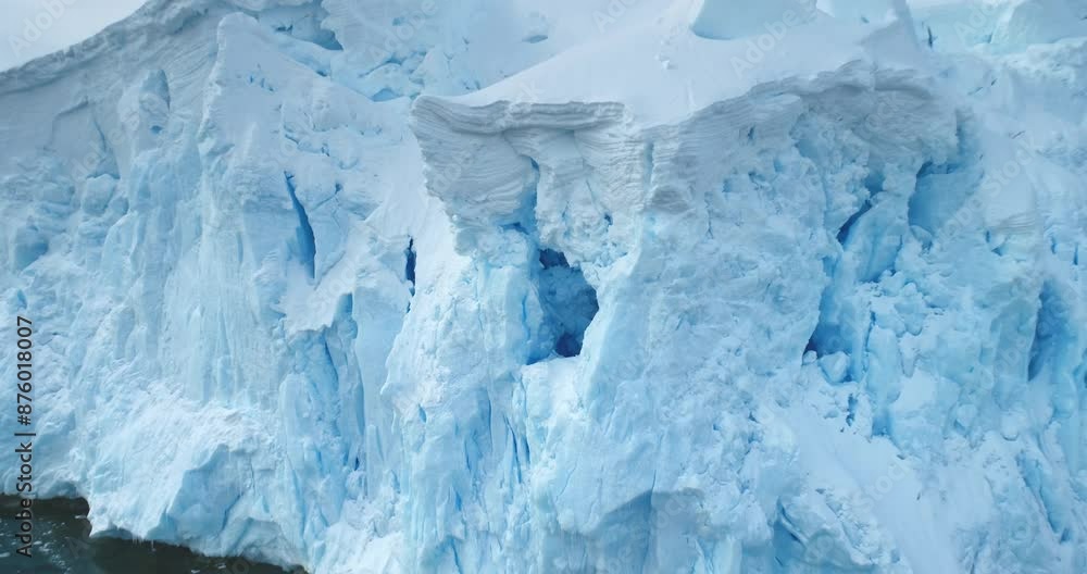 Global Warming and Climate Change - Giant glacier towers in Antarctica. Aerial drone view arctic nature winter landscape. Melting ice floes fjord in cold polar ocean. Global issue of melting icebergs Global Warming and Climate Change - Giant glacier towers in Antarctica. Aerial drone view arctic nature winter landscape. Melting ice floes fjord in cold polar ocean. Global issue of melting icebergs