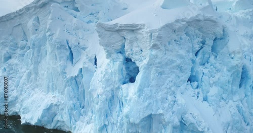 Global Warming and Climate Change - Giant glacier towers in Antarctica. Aerial drone view arctic nature winter landscape. Melting ice floes fjord in cold polar ocean. Global issue of melting icebergs
