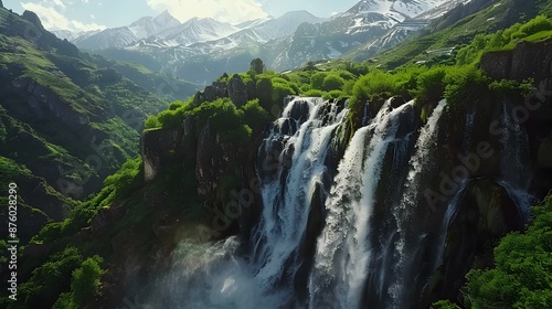 A waterfall in the mountains with raging water flows img