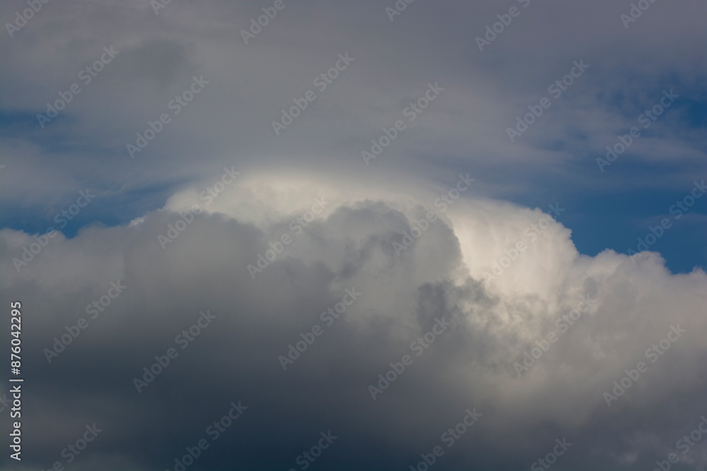 Formidable grey clouds in the sky before rain. Natural phenomenon gray clouds in the blue sky Formidable grey clouds in the sky before rain. Natural phenomenon gray clouds in the blue sky