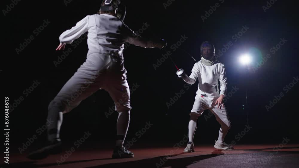Rivals Fencers Fighting With Epees In Darkness, Fencing Track For Match And Training, Combat Sports Rivals Fencers Fighting With Epees In Darkness, Fencing Track For Match And Training, Combat Sports