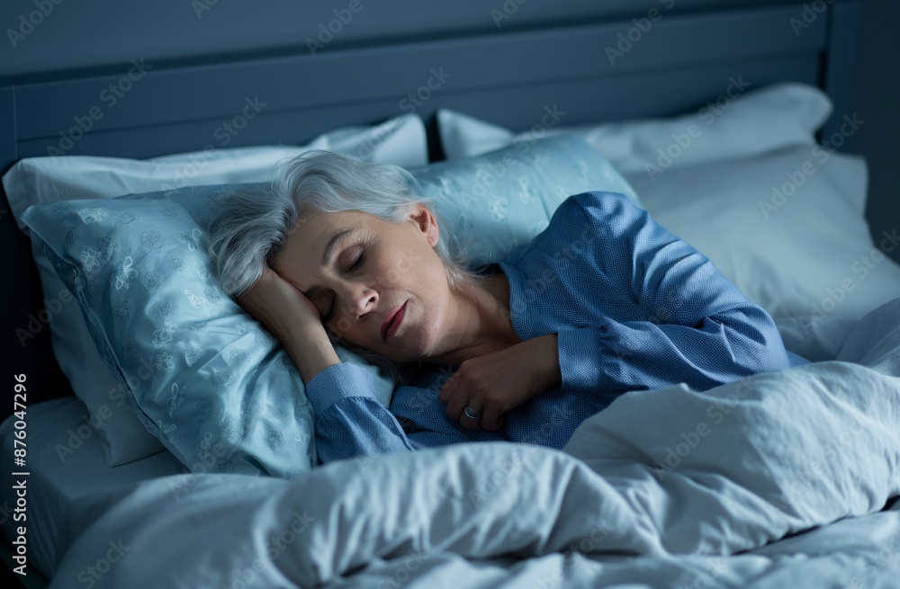 A woman sleeps soundly in bed, her face relaxed and eyes closed. The bedroom is dimly lit with an alarm clock on the nightstand.