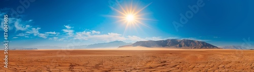 Sun shining bright over a vast, dry field. photo