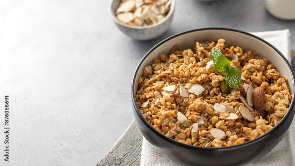 Crispy homemade granola with sliced almonds in a bowl. Healthy food. Copy space Crispy homemade granola with sliced almonds in a bowl. Healthy food. Copy space