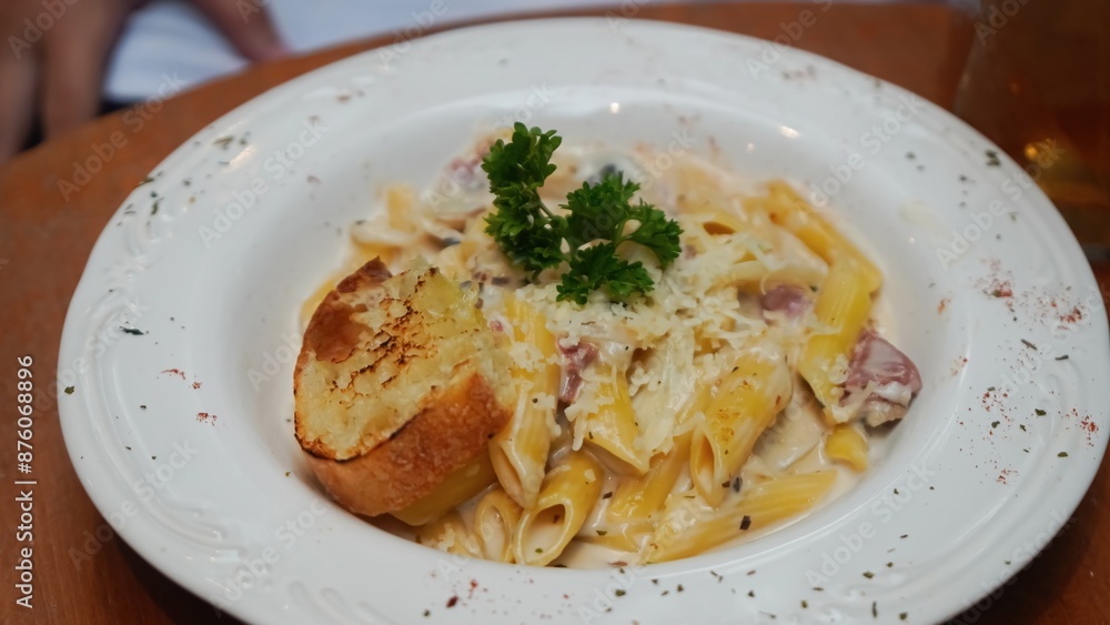 Creamy pasta with mushrooms, bacon, and a side of garlic bread. Creamy pasta with mushrooms, bacon, and a side of garlic bread.