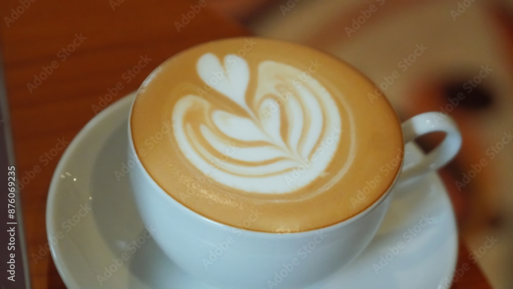 A white cup of coffee with latte art. A white cup of coffee with latte art.