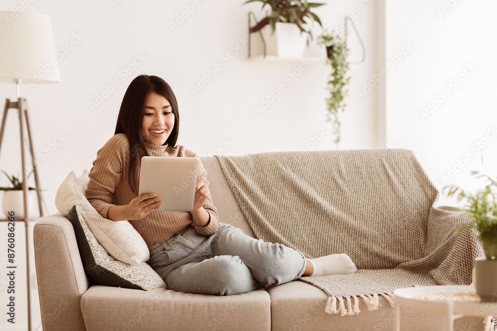 Φωτογραφία Asian Teenage Girl Watching Movie On Tablet, Resting at Home, Copy Space