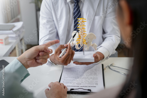 Doctor explaining spinal problem using anatomical model