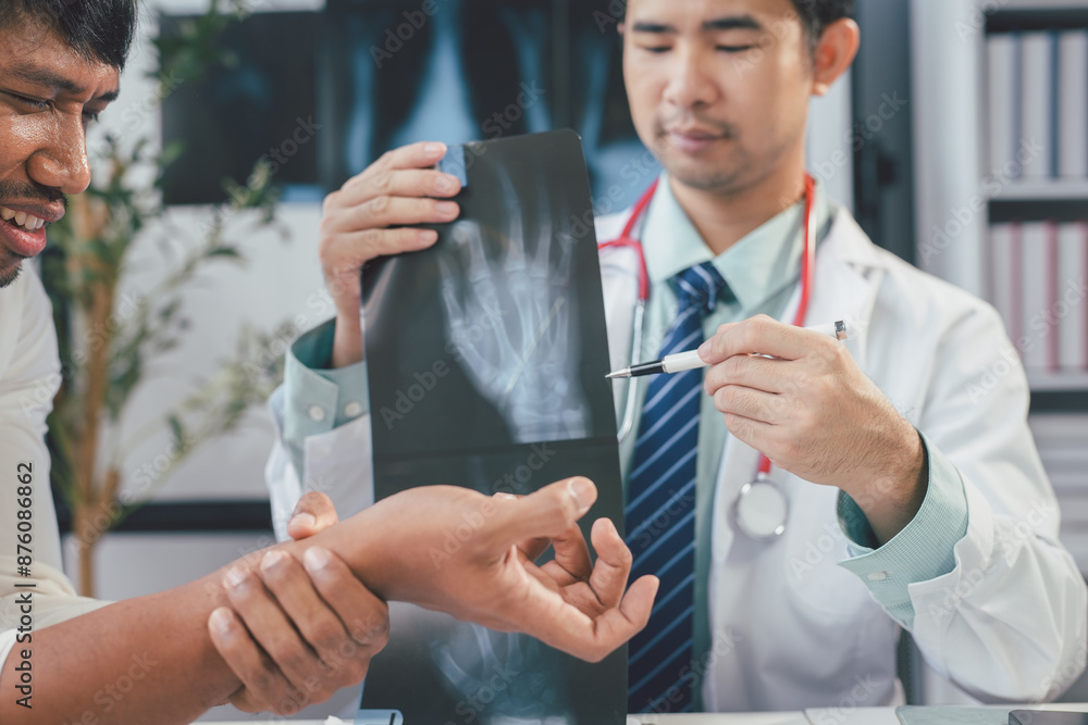 Doctor showing x-ray to patient suffering wrist pain Doctor showing x-ray to patient suffering wrist pain